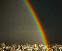 sorprendente luminosa arcobaleno al di sopra di città foto