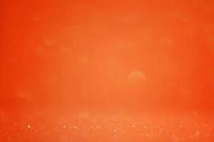 sfondo arancione glitter sfocato e parte focale stretta. sfondo festivo.