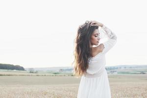 bella ragazza in un campo di grano in un abito bianco, un'immagine perfetta nello stile di vita