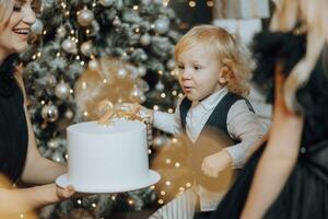 allegro e contento famiglia con Natale i regali festeggiare compleanno per Due anni. bambini siamo avendo divertimento. amorevole famiglia con i regali nel il camera. foto