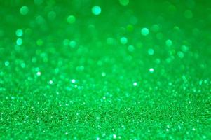 sfondo verde glitter astratto con luci sfocate foto