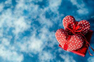 ai generato rosso i regali con rosa fiori su blu nuvoloso sfondo, contento San Valentino giorno concetto foto