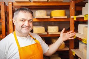 formaggio venditore nel negozio, casa produzione, attività commerciale, imprenditore. sorridente uomo, ritratto. uomo d'affari, vendita di formaggio prodotti. fatto con amore e cura. foto