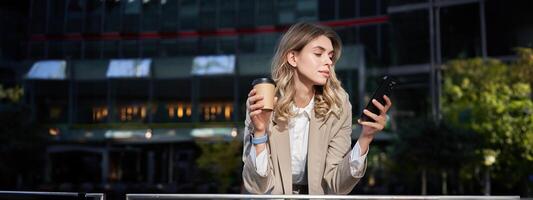 aziendale le persone. giovane donna d'affari potabile caffè, utilizzando smartphone app, riposo su pranzo rompere foto