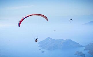 paracadute skydiver volante nel nuvole a superiore di montagne foto