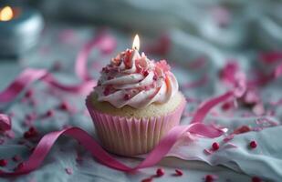 ai generato un' rosa Cupcake con un' candela e rosa nastri foto