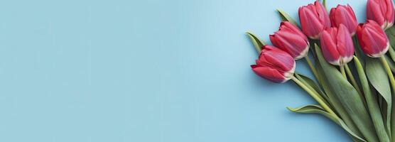 ai generato mazzo di rosso tulipano su blu sfondo. superiore Visualizza con copia spazio. ai generato foto