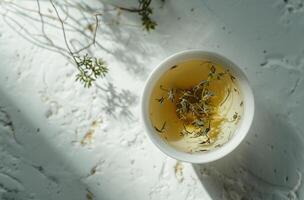 ai generato tazza di verde tè e erba su bianca sfondo foto