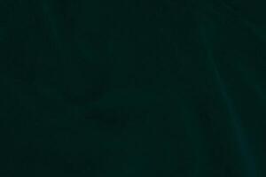 verde velluto tessuto struttura Usato come sfondo. Smeraldo colore felpa tessuto sfondo di morbido e liscio tessile Materiale. schiacciato velluto .lusso Smeraldo tono per seta.. foto