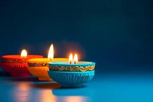 ai generato contento Diwali - argilla diya lampade illuminato su blu sfondo durante Diwali celebrazione, neurale Rete generato fotorealistico Immagine foto