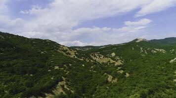 superiore Visualizza di ripido roccioso versante a superiore di verde montagna su sfondo di cielo. sparo. bellissimo roccioso superiore di pittoresco verde montagne foto