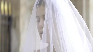 avvicinamento di sposa con velo e bianca vestito. azione. bellissimo delicato dettagli di della sposa vestito. bianca velo su giovane sposa foto