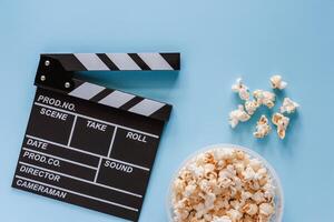 film battacchio tavola con Popcorn su blu sfondo foto