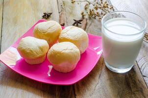 pane piatti e latte nel bicchiere su di legno pavimento. foto