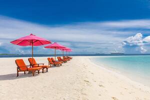 bellissimo tropicale spiaggia scenario. sole letti, lettini, ombrello sotto palma albero. bianca sabbia, mare Visualizza con orizzonte, colorato soleggiato cielo, quiete e rilassamento. ispirazione spiaggia ricorrere Hotel foto