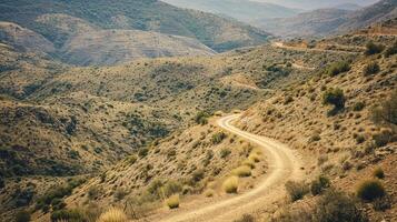 ai generato foto di strada attraversando attraverso aspro e scarso paesaggio. il strada dovrebbero essere stretto e non asfaltato, serpeggiante suo modo salita in mezzo il brunastro verde terreno ai generato