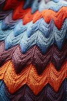 ai generato verticale Immagine blu, Marrone e arancia a maglia lana tessuto macro struttura sfondo, morbido e accogliente tessere fantasia superficie foto