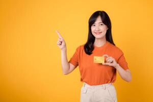 gioioso asiatico ragazza con un' credito carta pronto per in linea acquisti, veicolare finanziario fiducia e moderno pagamento metodi. foto