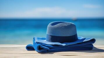 ai generato blu spiaggia asciugamano accompagnato di un' cappello, simboleggiante estate rilassamento, ai generato foto