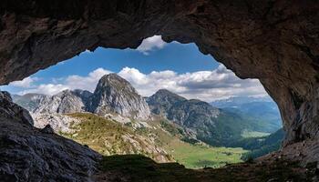 ai generato un' Visualizza di il montagne a partire dal dentro un' grotta foto