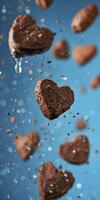 ai generato cioccolato biscotti nel il forma di cuori volante contro un' blu sfondo foto