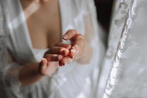 avvicinamento di un elegante diamante squillare su un' donna di dito con un' moderno manicure, luce del sole. amore e nozze concetto. morbido e selettivo messa a fuoco. foto