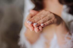 avvicinamento di un elegante diamante squillare su un' donna di dito con un' moderno manicure, luce del sole. amore e nozze concetto. morbido e selettivo messa a fuoco. foto