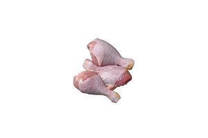 crudo pollo gambe con sale, spezie e erbe aromatiche su un' buio calcestruzzo sfondo foto