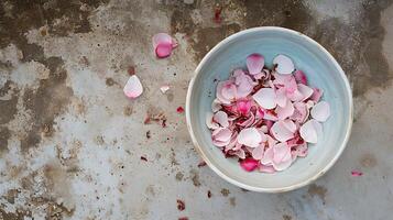 ai generato rosa petali nel bianca ciotola su rustico terra foto