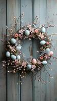 ai generato Pasqua ghirlanda fatto di primavera fiori, salice ramoscelli, e Pasqua uova su di legno superficie. ai generato foto