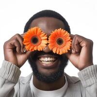 ai generato africano americano uomo coperture occhi con Due arancia gerbere foto