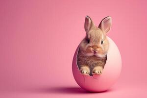 ai generato un' carino giovane Marrone coniglio sbirciando su un' rosa uovo su rosa sfondo. generativo ai. foto