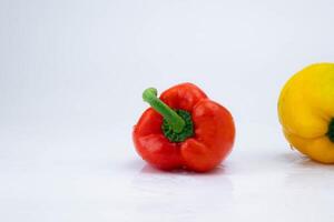 Due campana peperoni isolato su bianca sfondo. campana peperoni di vario colori su un' bianca sfondo. foto