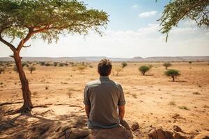 ai generato un' uomo sembra in il distanza a un' deserto. generato di artificiale intelligenza foto