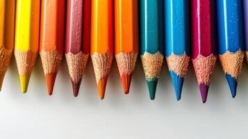 ai generato colorato matite menzogna nel un' riga su un' luminosa minimalista sfondo foto