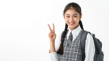 ai generato contento bella asiatico alunno ragazza nel scuola uniforme puntamento dito su isolato su bianca sfondo. foto
