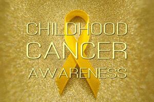 oro nastro per bambini come un' simbolo di infanzia cancro consapevolezza. mondo cancro giorno foto