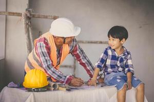 ingegnere costruttore famiglia padre giorno ruolo giocare insegnamento figlio ragazzo a costruzione luogo foto