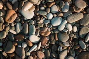 pietra ciottoli su il spiaggia come un' backround foto