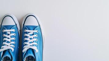 ai generato blu tela scarpe isolato su piatto bianca sfondo con copia spazio per annuncio. generativo ai foto