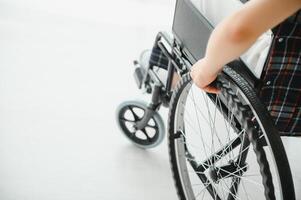 donna nel sedia a rotelle mano su ruota vicino su foto