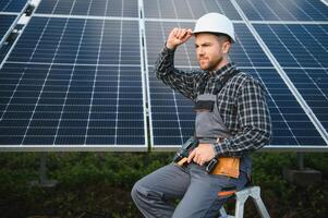 maschio lavoratore nel uniforme all'aperto con solare batterie a soleggiato giorno. foto