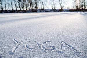 un' Messaggio nel il neve. yoga nel il fresco aria. il parola yoga è scritto nel il neve. un' minimalista immagine di zen buddismo. pace e la tranquillità. foto