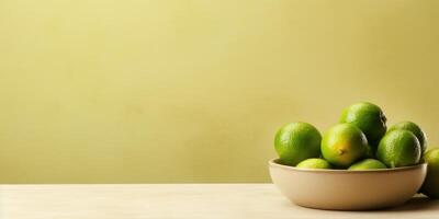 ai generato ciotola di fresco verde Limes su tavolo con giallo sfondo. generativo ai foto