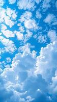 ai generato vivido blu cielo e nuvole sfondo, un' naturale luce del giorno panorama verticale mobile sfondo foto