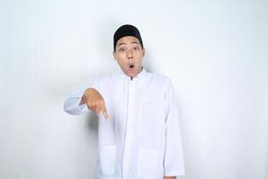 scioccato asiatico uomo musulmano puntamento giù sotto isolato su bianca sfondo foto