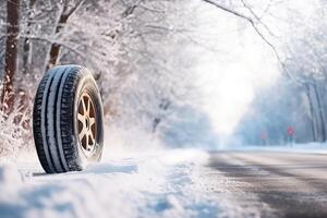 ai generato marca nuovo inverno auto pneumatici in mostra contro un' nevoso strada sfondo. cy viaggio, ruota inverno pneumatici foto