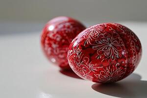 ai generato Due rosso Pasqua uova con un' dipinto modello su un' bianca sfondo avvicinamento. generativo ai foto