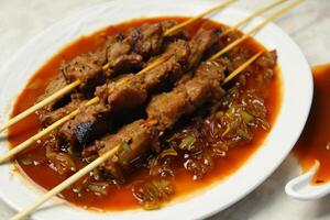 indulgere nel il bellezza di bellissimo satay, dove spiedini di marinato diletto siamo alla brace per d'oro perfezione, offerta un' sinfonia di gusto nel ogni mordere, un' culinario abilità artistica per assaporare foto