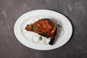 pollo tandoori con cipolla servito nel piatto isolato su sfondo superiore Visualizza di bangladesh cibo foto